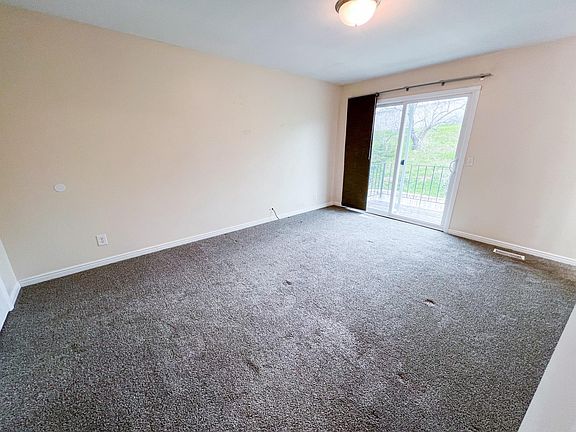 Large primary bedroom with balcony