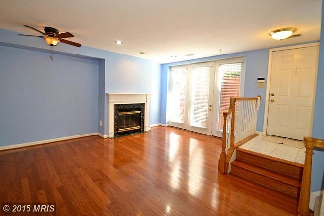 Living room area with gas fireplace, with doors to patio
