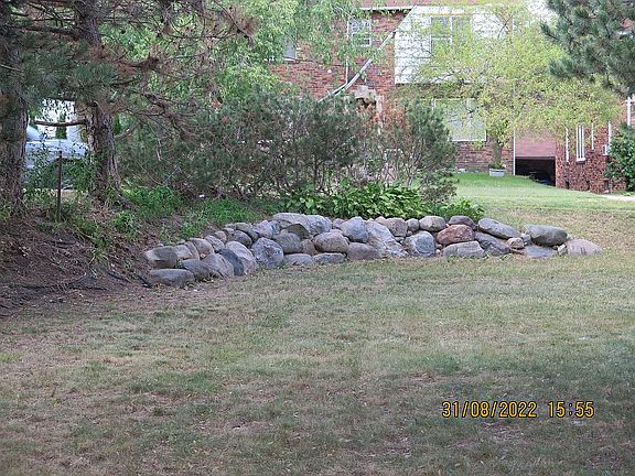 Front side yard w/ rock wall