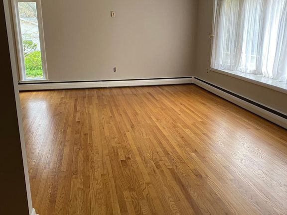 Living room, full of natural light and gorgeous hardwood floors