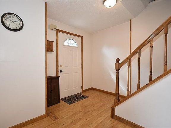 Beautiful laminate hardwood floors run from the entry through the dining room, kitchen, and large family room.