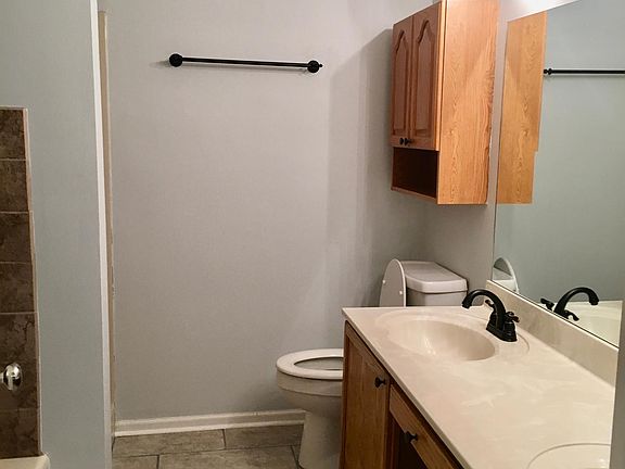 Master bath with double vanity, walk-in shower, and separate tub