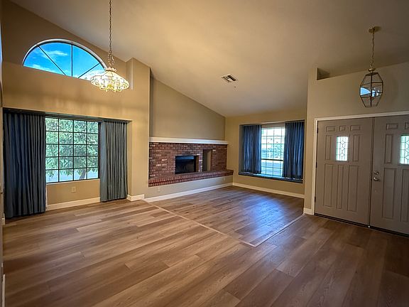 Dinning area and Living room opening, brick wood fireplace and window seating area