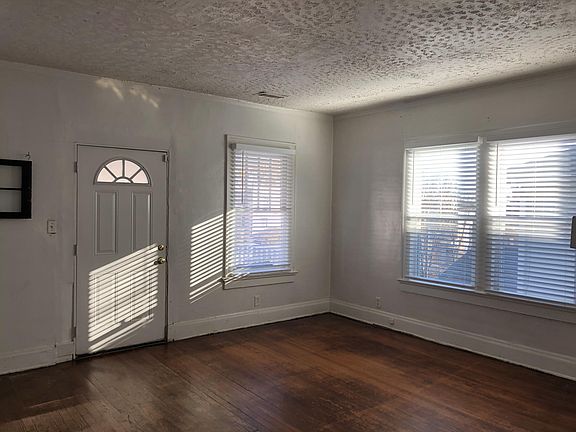 Spacious living room with door to upstairs porch