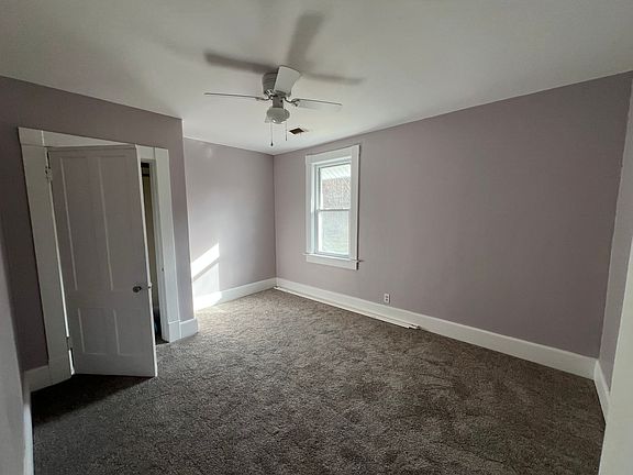 Bedroom with closet and ceiling fan.