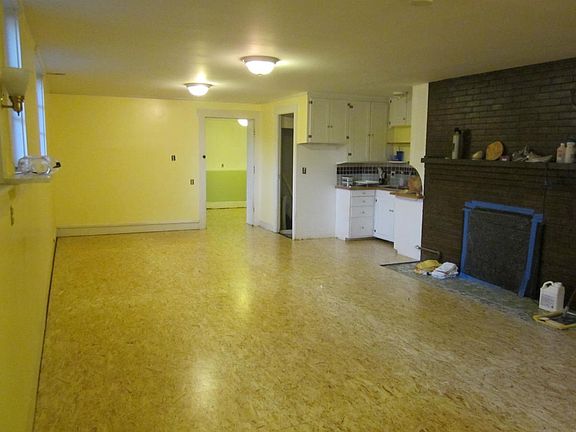 another angle of main room and kitchenette with gar fireplac