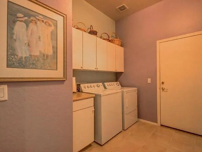 Large washer and dryer room next to garage. Washer and dryer is an upgraded model. Functions perfectly.