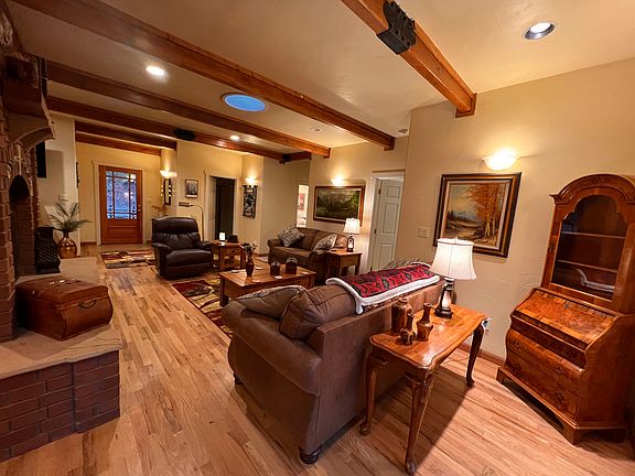 Large rustic wooden beams add a lodge feel to room.