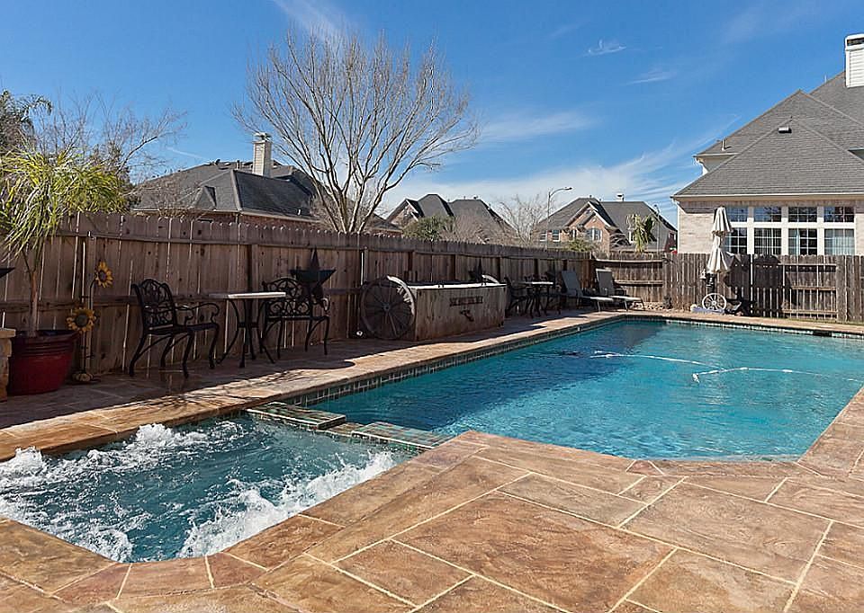 Newly resurfaced deck surrounds the pool and spa.