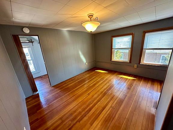 bedroom with large walk in closet with additional ample eave storage