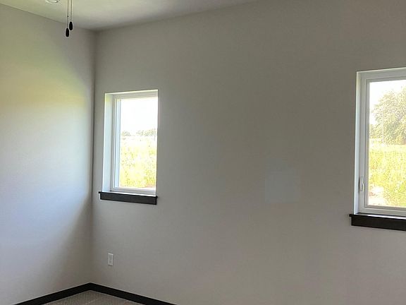 Master bedroom with ceiling fan light and 2 windows!