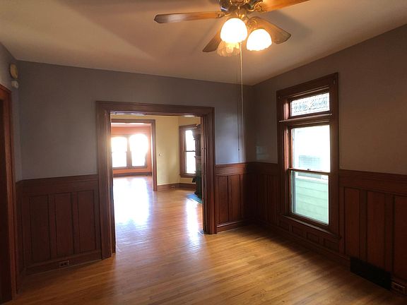 standing in dining room, looking through fireplace room, into front room