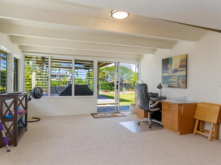 Flex room. There is a retractable partition that can be used to close this room off from the family room when privacy is required. Use this room as an office or exercise room! Access the back yard and pavilion through this sliding glass door.