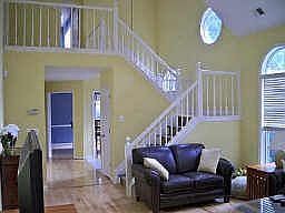 Living room faces stairs to second floor with additional bedrooms and bathroom