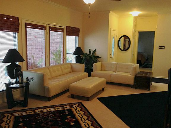 Living area loaded with windows.  Fresh carpet and paint.  High ceilings.