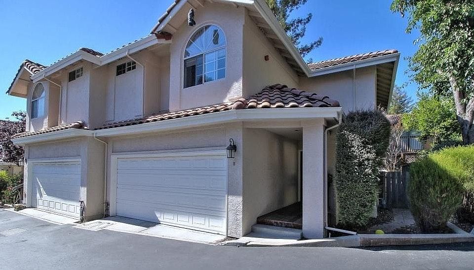 Located in a peaceful and secure community, this attractive townhouse features classic stucco siding and a Spanish-style tile roof, combining timeless design with a welcoming feel.