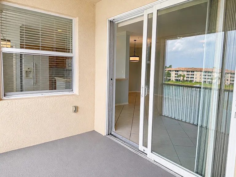 Screened lanai with sliding glass doors for seamless indoor-outdoor living