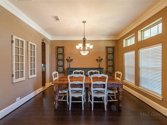 Pretty dining room with gorgeous wood-like flooring.