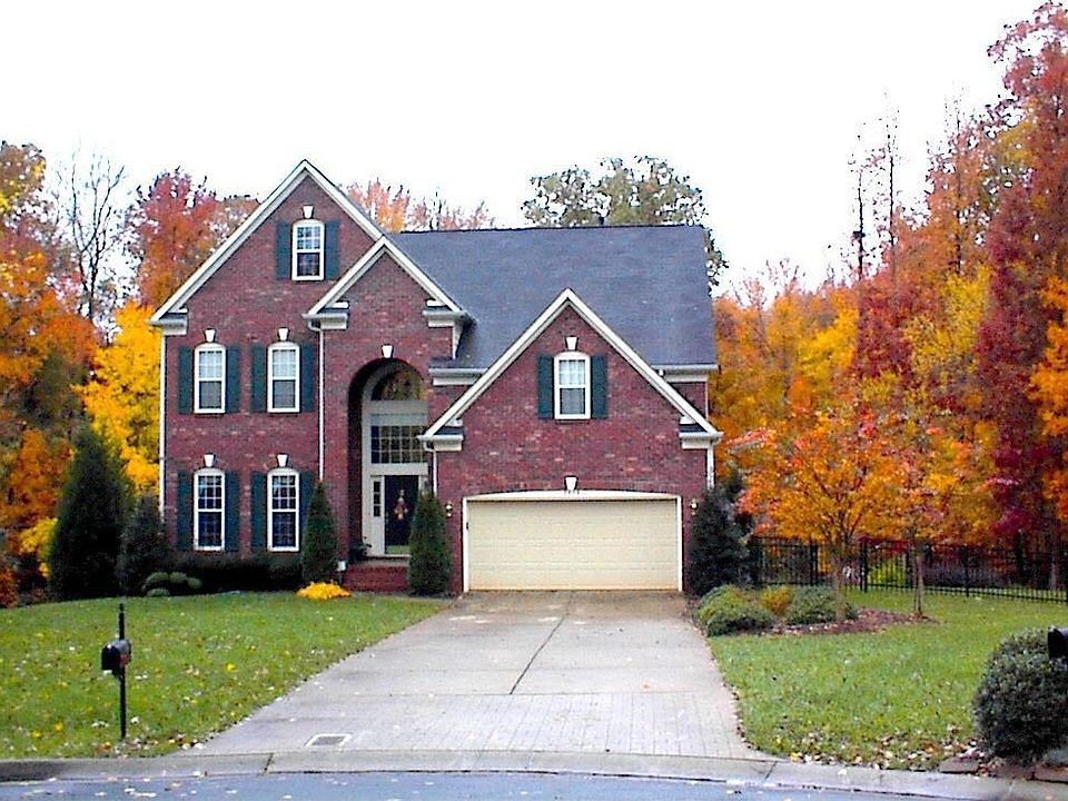 Front of home - gorgeous landscaping w/ fenced yard