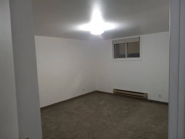 Large first bedroom; located in basement. Ample room for king-size bed and dressers