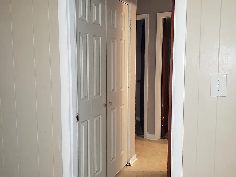 hallway with velour doors to the linen and other accessories