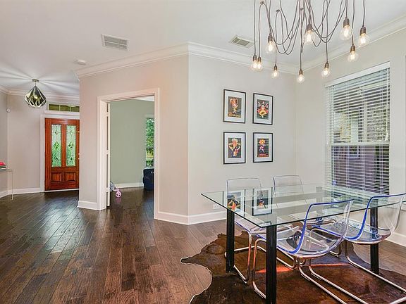 Beautiful foyer greets you with wood floors, fresh paint and updated light fixtures.
