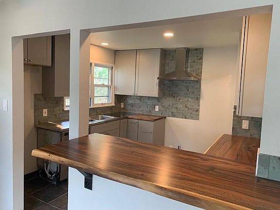 Everything in the kitchen is brand new, including all the stainless appliances, high end tile, stainless and wood slab counters.