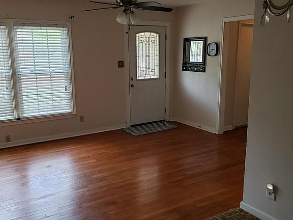 Enter front door to original hardwood flrs, ceiling fan and dining light to right.