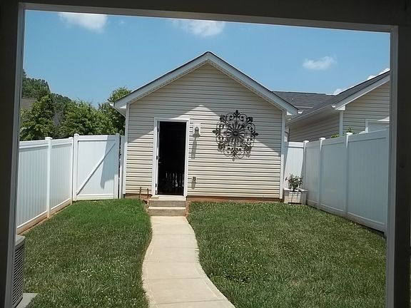 Fenced in yard with garage