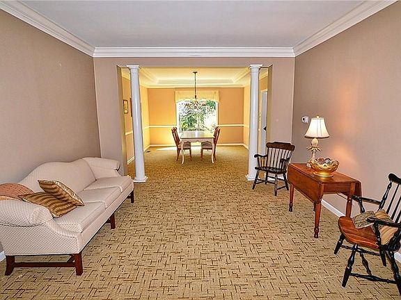 The formal living room is open to the formal dining room and separated with decorative columns.