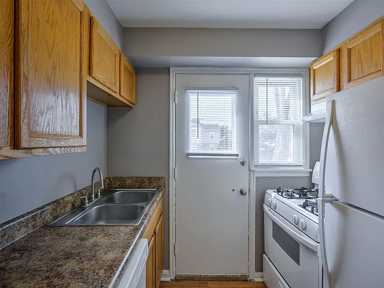 Kitchen with a back door at Colonial Park.