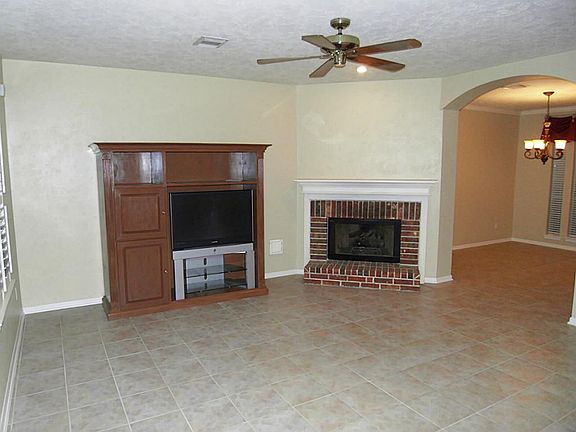DEN WITH BEAUTIFUL TILE AND WOOD BURNING FIREPLACE
