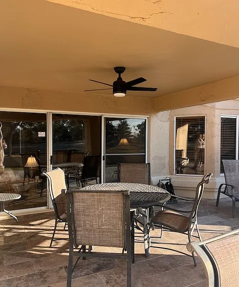 Back patio with fan for dining and entertainment. Large stainless propane bbq.