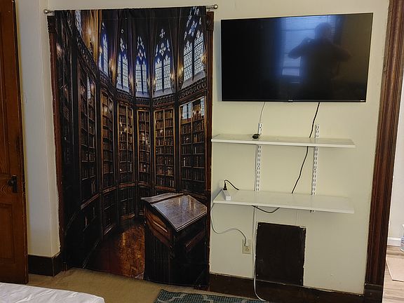 The "Harry Potter Library" curtains hide a nice big closet and 43" Roku TV is provided.