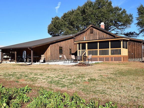 Wood cabin with screened porch and fire pit patio