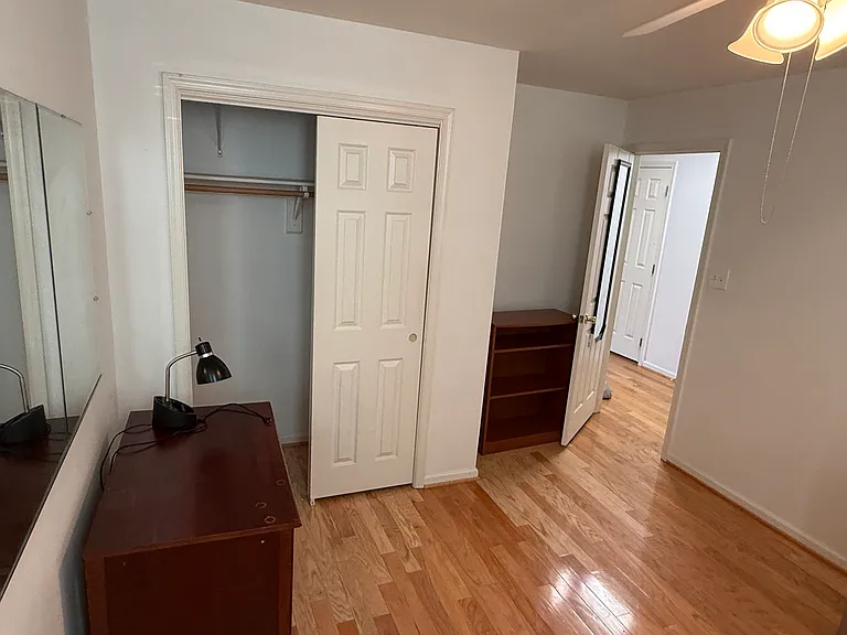 1 bedroom with 2 windows, ceiling fan/light, desk, bookcase, closet.