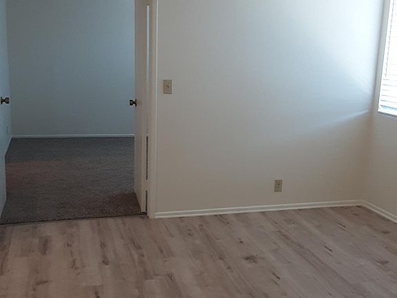 Dining Area with double door entrance into plush carpeted bedroom.