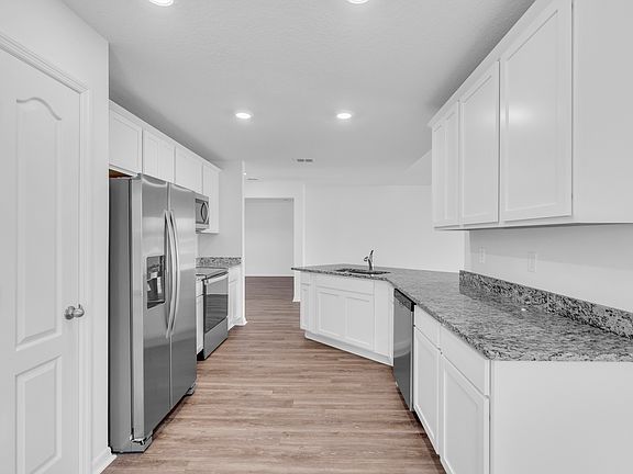 This kitchen is chef-ready with stainless steel appliances and plenty of space to cook