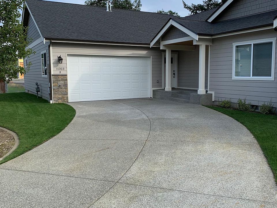 2018 modern duplex Unit B. Private driveway and two-car garage.