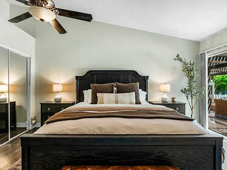 1st /Primary Bedroom with bathroom and walk in closet, TV - private access to patio/backyard