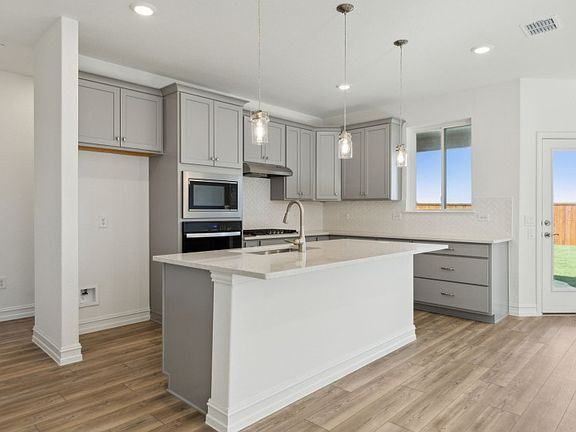 Bright kitchen with ample cabinet space and oversized island