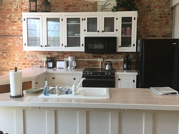 Open Kitchen w/ exposed brick walls.
