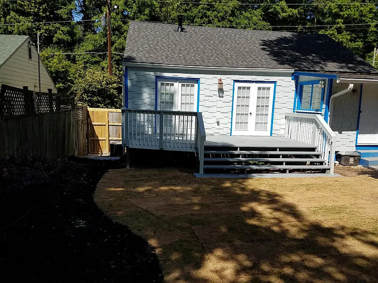 At the left back fence looking at the house