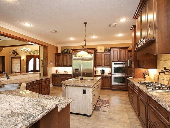 Custom kitchen with tons of cabinets. Double Oven, Built in subzero refrigerator, gas stove and pot filler plus warming drawer! Great home for entertaining!
