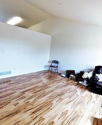 Formal living w new flooring and vaulted ceilings greet you as you walk in the door