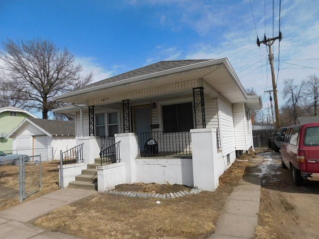 front covered porch and fenced yard