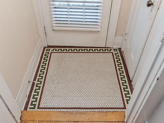 Original period tile entry vestibule with coat closet. Perfect for greeting guests.