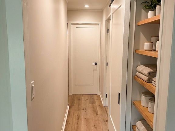 Hallway - Primary Bedroom at end, bathroom to the right, other two rooms to the left.