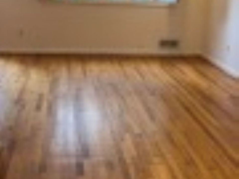 Living Room facing front. Windows have folding shutters.