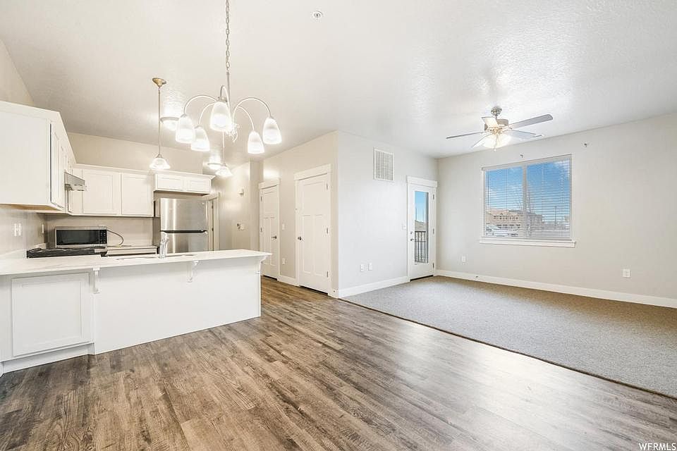 Open concept: kitchen, dining room, living room - door to outside patio for mountain view.